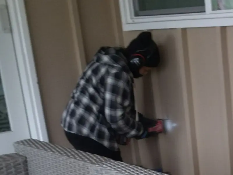 Professional electrician installing an exterior outlet in Genesee