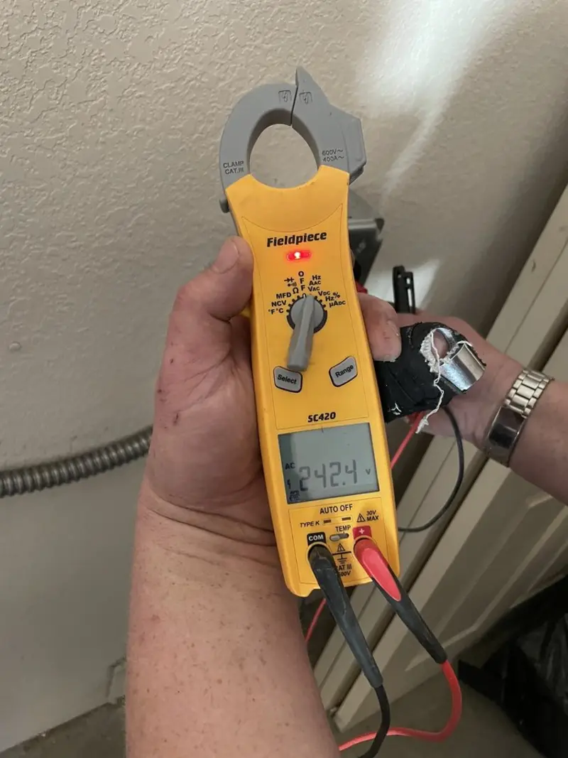 Voltage testing with clamp meter during Outlet Installation in Genesee